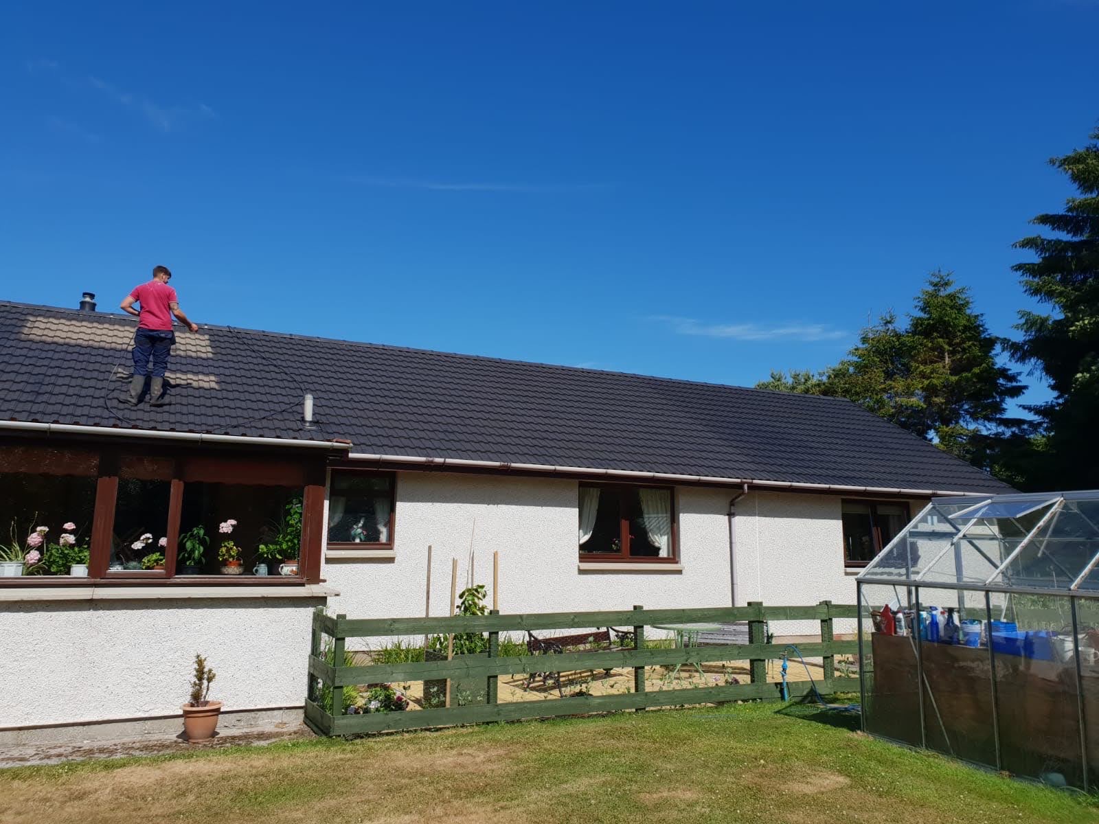 Professional roof cleaning in progress